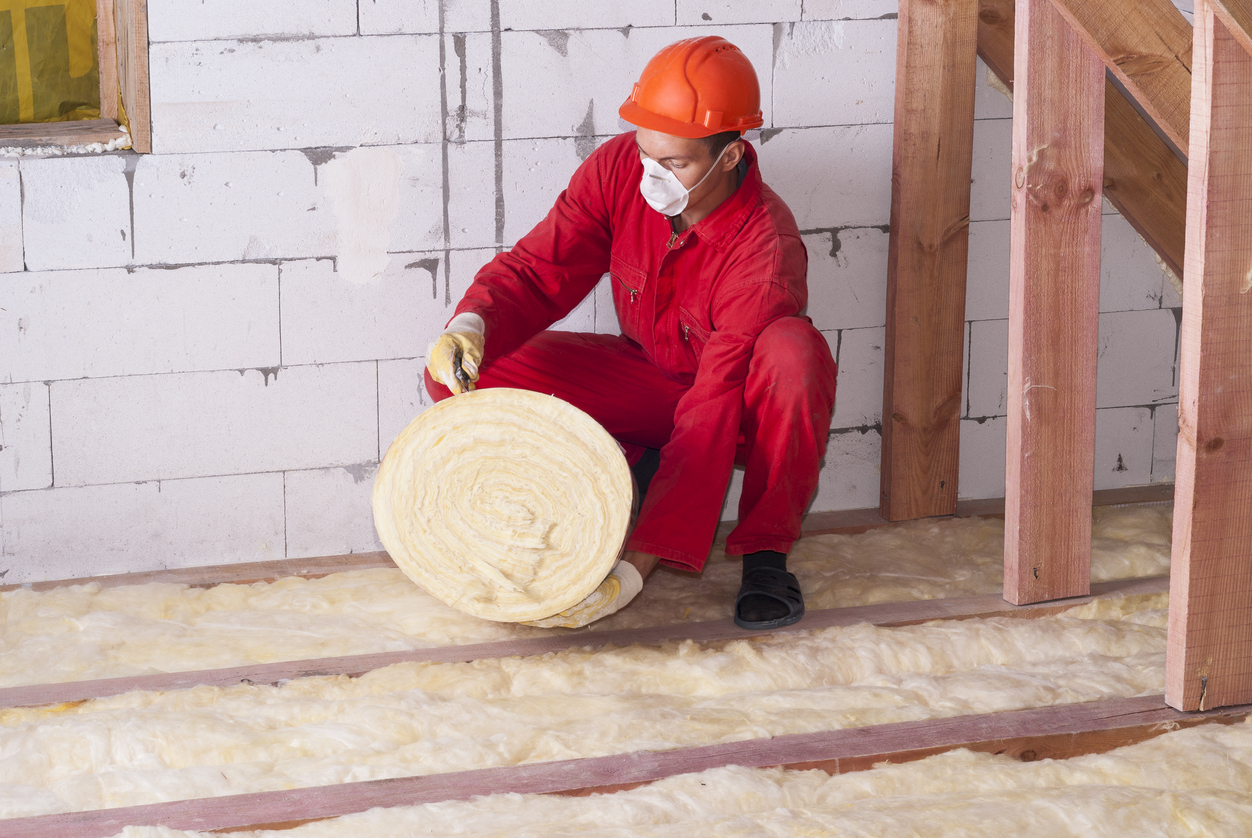 Man installing attic insulation