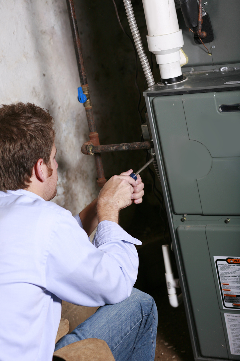 repairman working on furnace